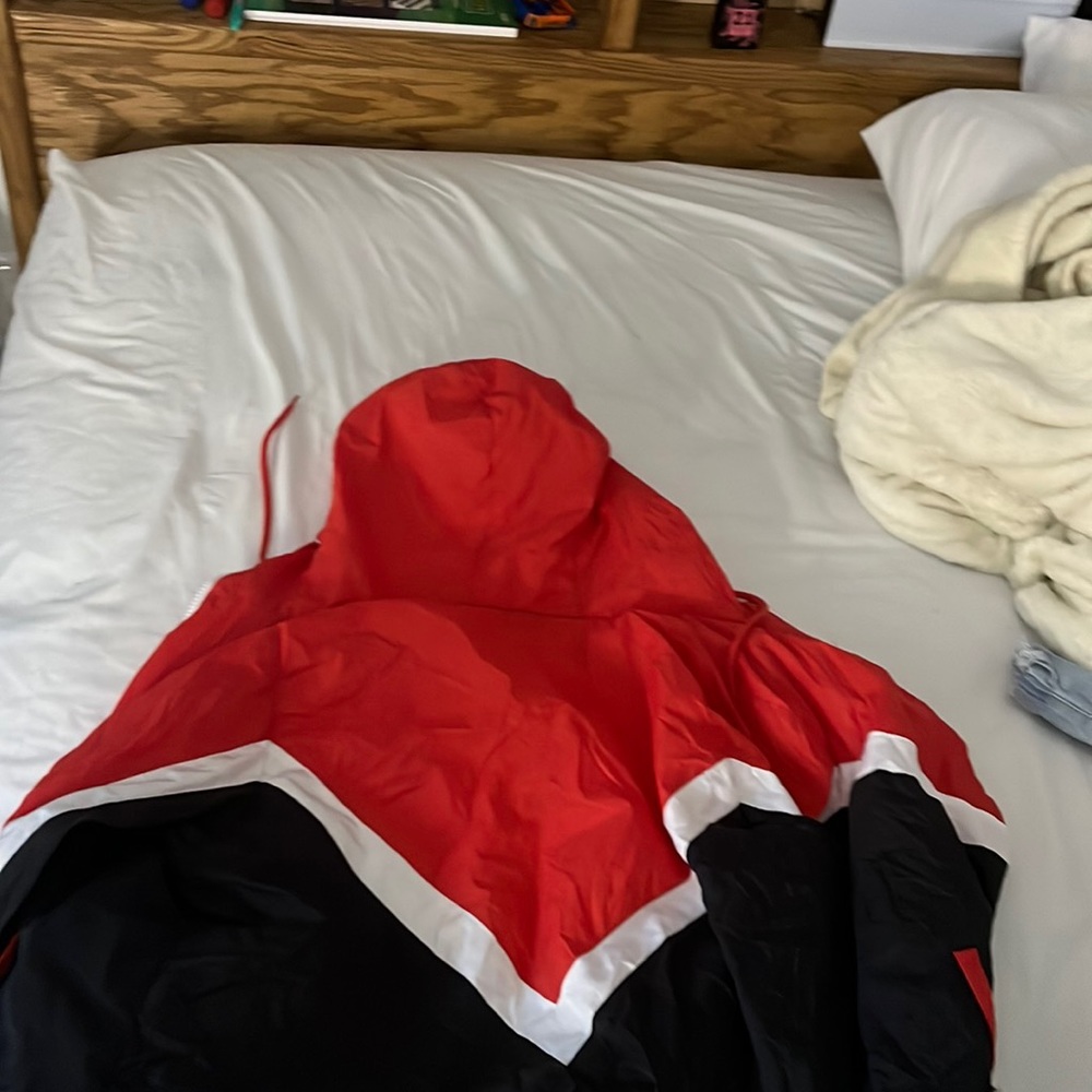 red black and white windbreaker left pocket is a little ripped